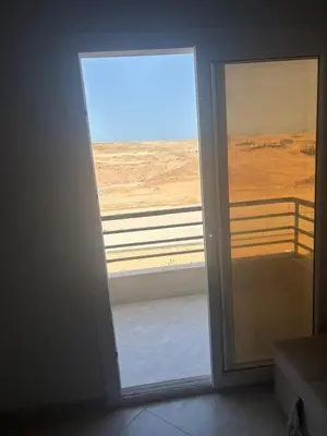 a door to a room with a view of the desert at Apt at Panorama view in Hurghada
