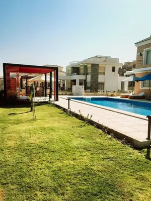 a house with a swimming pool in a yard at VIP villa heated pool & Spa & fully entertained in Hurghada