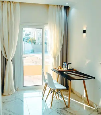 a table and a chair in a room with a window at VIP villa heated pool & Spa & fully entertained in Hurghada