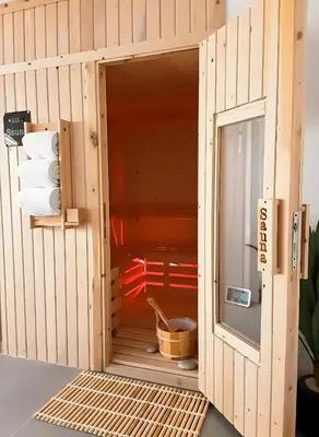 a wooden sauna with a door open into a room at VIP villa heated pool & Spa & fully entertained in Hurghada