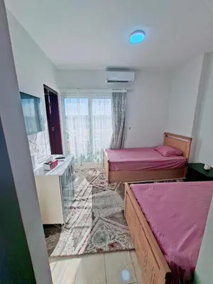 a room with two beds and a sink in it at Hurghada Resort in Hurghada