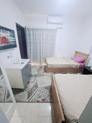 a small room with two beds and a sink at Hurghada Resort in Hurghada