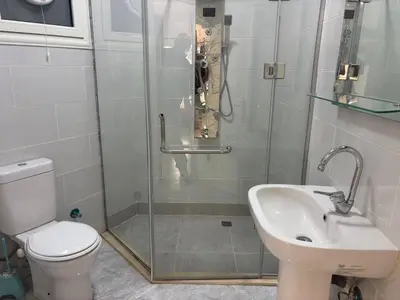 a bathroom with a shower and a toilet and a sink at Aqua palms in Hurghada
