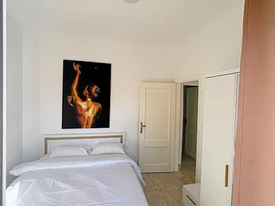 a bedroom with a bed and a painting on the wall at Aqua palms in Hurghada