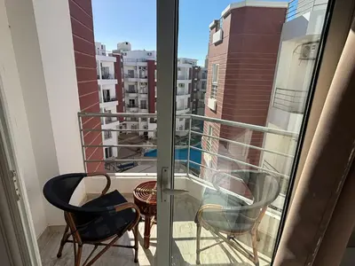 a balcony with two chairs and a table at Aqua palms in Hurghada