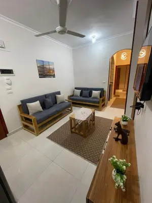 a living room with a couch and a table at Luxe Nest Luxor Serviced Apartments 202 in Luxor