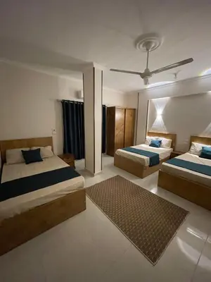 a bedroom with two beds and a rug at Luxe Nest Luxor Serviced Apartments 202 in Luxor