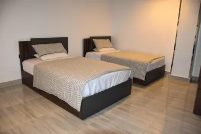 two beds sitting in a room with at Quiet Corner Apartment in Luxor