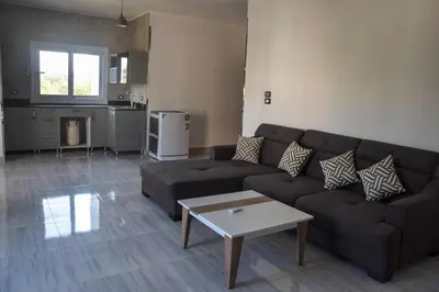 a living room with a couch and a table at Quiet Corner Apartment in Luxor