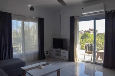 a living room with a couch and a tv at Quiet Corner Apartment in Luxor