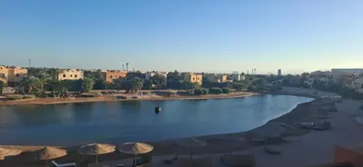 a view of a river with umbrellas and a city at El Gouna Upper nubia in Hurghada
