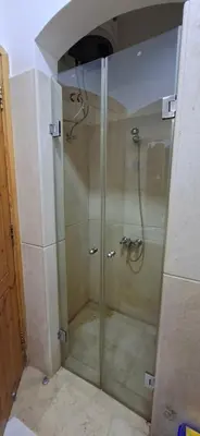 a shower with a glass door in a bathroom at El Gouna Upper nubia in Hurghada