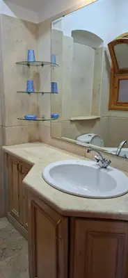 a bathroom with a white sink and a mirror at El Gouna Upper nubia in Hurghada