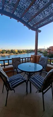 a patio with a table and chairs and a view of the water at El Gouna Upper nubia in Hurghada