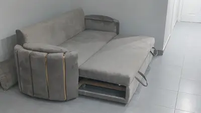 a couch and a stool in a room at Amazing studio in Scandic resort in Hurghada