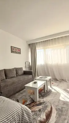 a living room with a couch and a coffee table at Amazing studio in Scandic resort in Hurghada