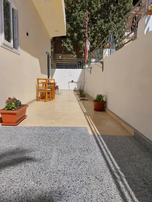 an empty patio with a table and chairs in a house at Desert Daisy in Luxor