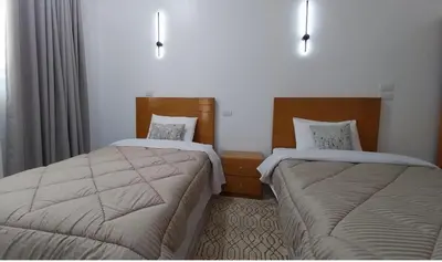 a hotel room with two beds in a room at Desert Daisy in Luxor