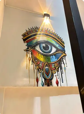 a painting of an eye on a wall at Luxor Temple & Local Life at Your Doorstep Al FahadAprtments in Luxor