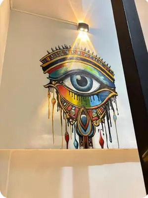 a painting of an eye on a wall at Luxor Temple & Local Life at Your Doorstep Al FahadAprtments in Luxor