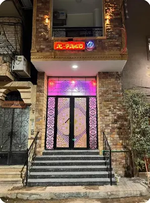 a front door of a building with a stained glass window at Luxor Temple & Local Life at Your Doorstep Al FahadAprtments in Luxor