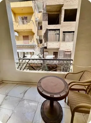a table in a room with a view of a building at Luxor Temple & Local Life at Your Doorstep Al FahadAprtments in Luxor