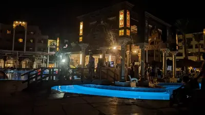 a blue pool in front of a building at night at Pause by The Sea Hurghada, Stay, Relax, Repeat in Hurghada