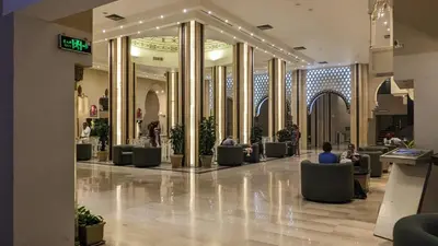 a lobby with people sitting in chairs in a mall at Pause by The Sea Hurghada, Stay, Relax, Repeat in Hurghada