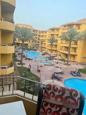 a view of a resort with tables and chairs at الكوثر المنتجع البريطاني البريتش ريزورت in Hurghada