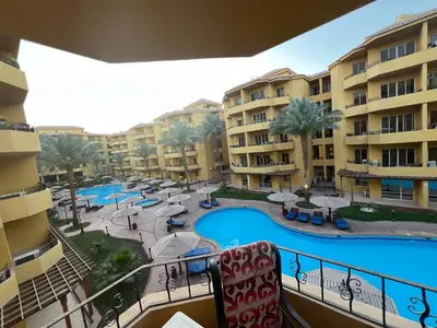 a view of a pool from a balcony of a resort at الكوثر المنتجع البريطاني البريتش ريزورت in Hurghada