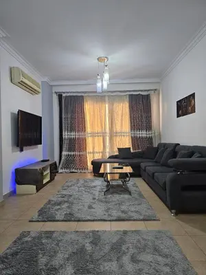 a living room with a couch and a table at الكوثر المنتجع البريطاني البريتش ريزورت in Hurghada