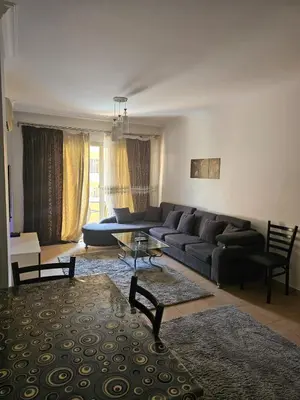 a living room with a couch and a table at الكوثر المنتجع البريطاني البريتش ريزورت in Hurghada