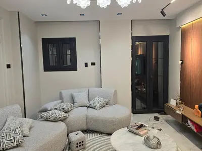 a living room with a couch and a table at Rayan Apartment in Asyut