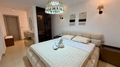 a bedroom with a large bed in a room at Kuba luxury loft in Hurghada
