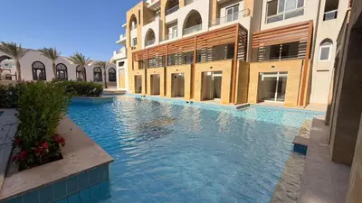 a swimming pool in the middle of a building at Kuba luxury loft in Hurghada