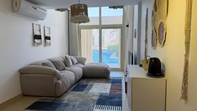 a living room with a couch and a table at Kuba luxury loft in Hurghada