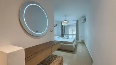 a bedroom with a bed and a large mirror at Kuba luxury loft in Hurghada
