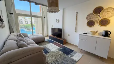 a living room with a couch and a tv at Kuba luxury loft in Hurghada
