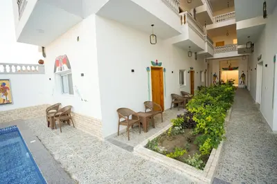 a courtyard with a garden in the middle of a building at Astralis Hotel in Al Aqālitah
