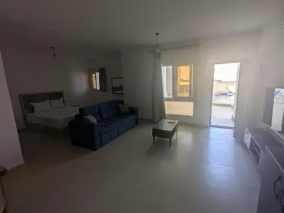 a living room with a bed and a couch at Magawish Studio #3 with pool view in Hurghada