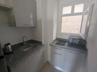 a small kitchen with a sink and a window at Magawish Studio #3 with pool view in Hurghada
