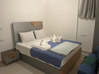a bedroom with a bed with towels on it at Magawish Studio with Pool in Hurghada