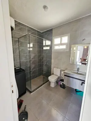 a bathroom with a shower and a toilet and a sink at Magawish Studio with Pool in Hurghada