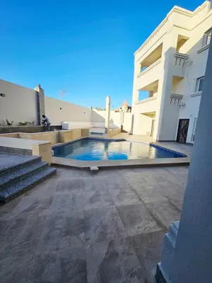 a swimming pool in front of a building at Magawish Studio with Pool in Hurghada