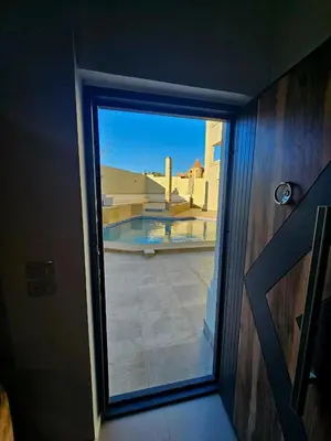 a door to a room with a view of a balcony at Magawish Studio with Pool in Hurghada