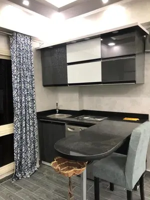a kitchen with a table and a sink and a stove at West Side Village in Hurghada