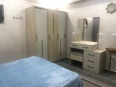 a bedroom with a bed and a sink and a mirror at West Side Village in Hurghada