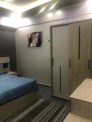 a bedroom with a bed and a sliding door at West Side Village in Hurghada