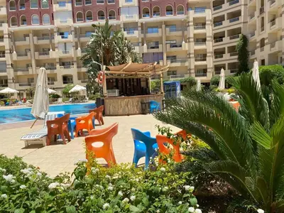 a group of chairs sitting next to a swimming pool at Florenze J113 Hurghada in Hurghada