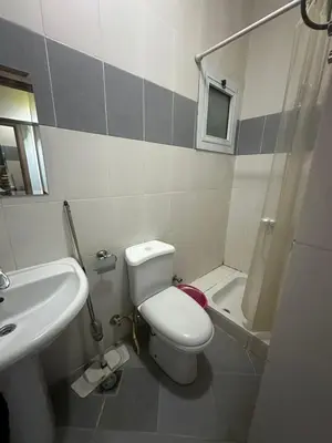 a bathroom with a white toilet and a sink at Desert Pearl Lux in Hurghada